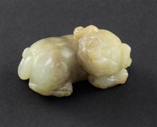 A Chinese celadon and brown jade figure of a recumbent lion-dog, 19th century, 5cm